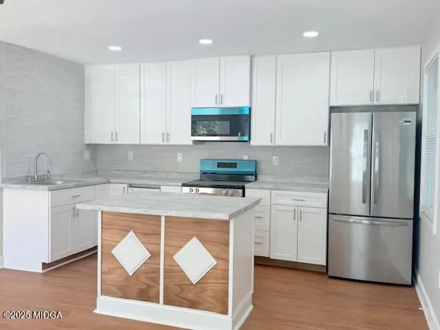 a kitchen with a refrigerator stove top oven and cabinets