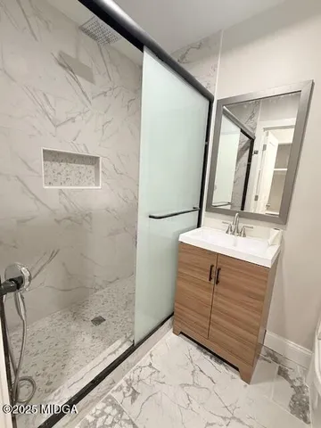 a bathroom with a sink a mirror and shower