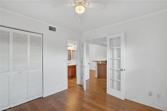 a view of empty room with wooden floor