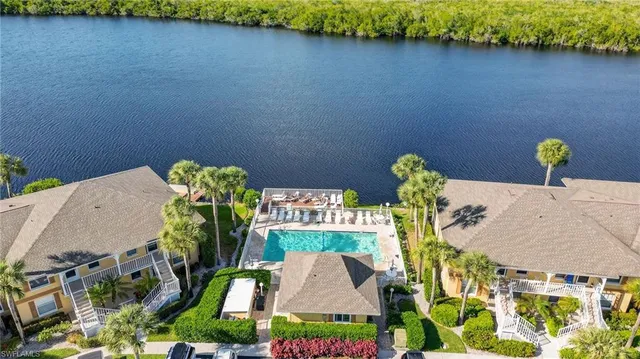 an aerial view of a house with swimming pool garden and patio