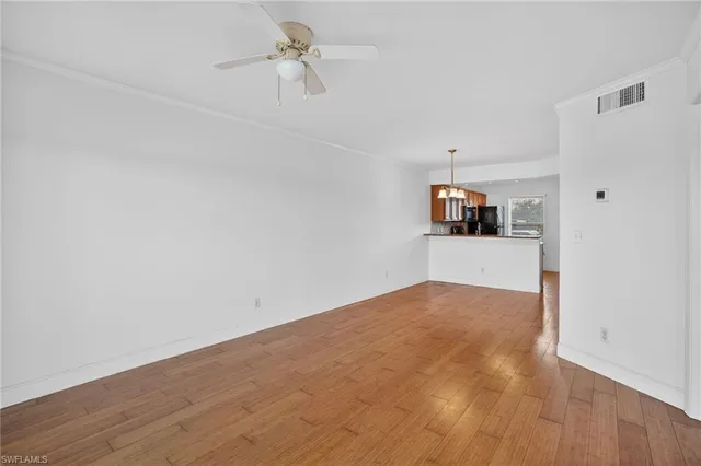 a view of a room with wooden floor and cabinet