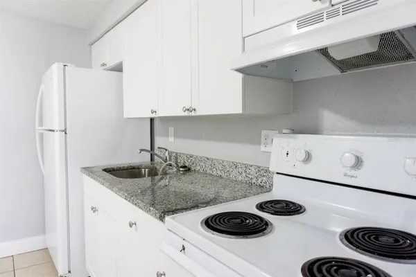 a kitchen with a sink and a refrigerator