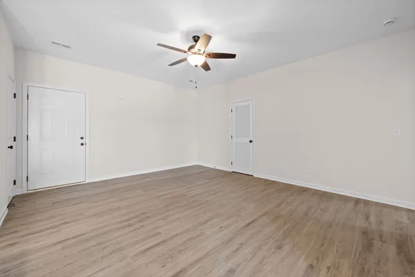a kitchen with stainless steel appliances granite countertop a sink a stove a refrigerator and island with wooden floor
