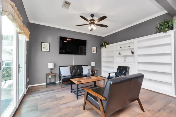 a living room with furniture and a wooden floor