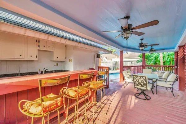 a large kitchen with a table and chairs
