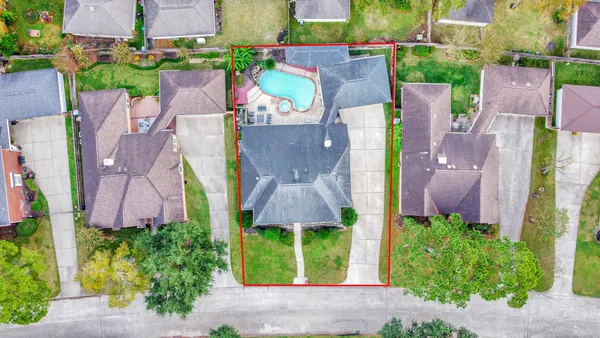 an aerial view of multiple houses with yard