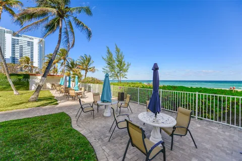 a view of a patio with a table and chairs