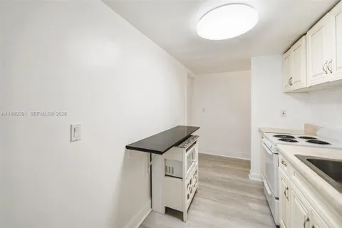 a kitchen with a stove and cabinets