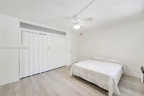 a bedroom with a bed and a ceiling fan
