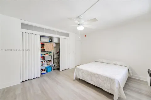 a bedroom with a bed and a book shelf