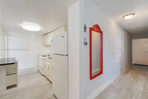 a room with white cabinets and entryway