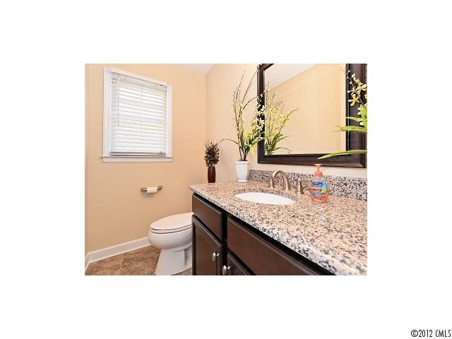 4443 Carmel Road Charlotte, NC 28226 - Photo 13 of 16 a bathroom with a granite countertop sink toilet and mirror