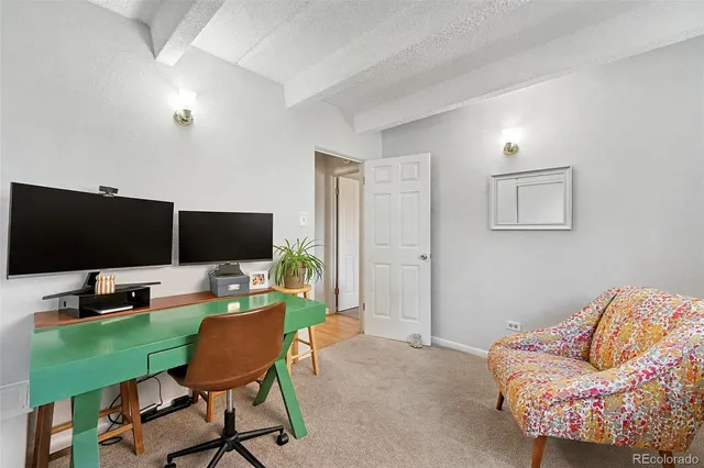 a work room with furniture and a flat screen tv