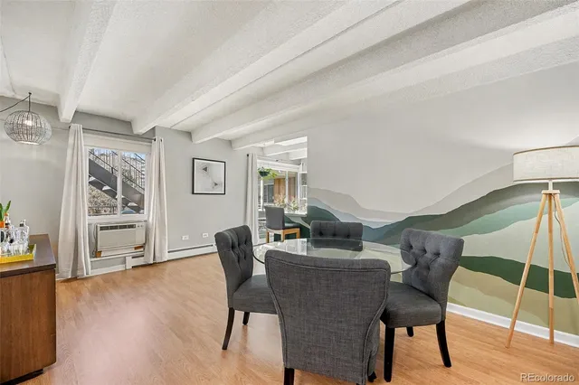 a dining room with furniture and wooden floor