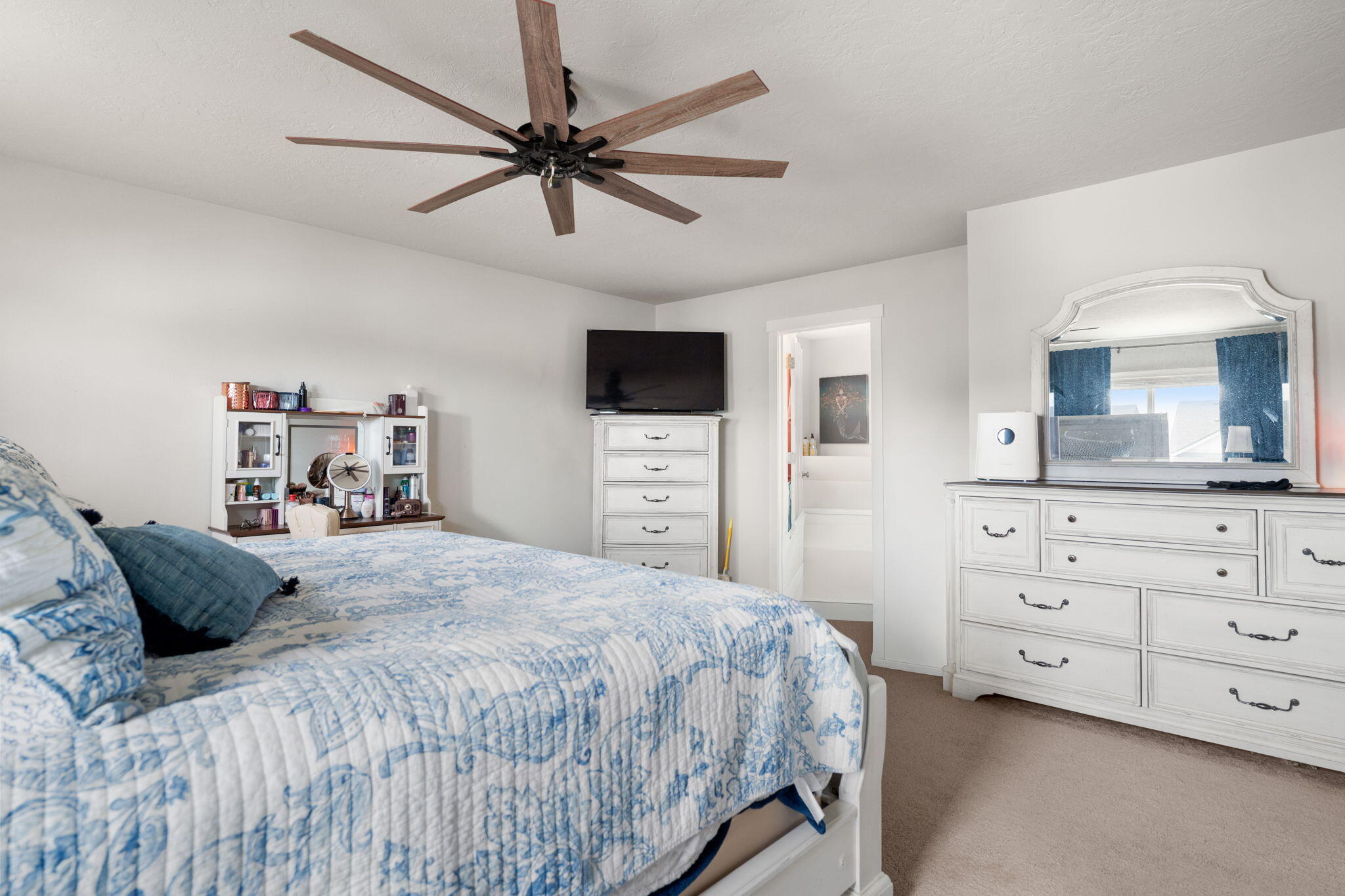 4039 Southwest Quartz Place Redmond, OR 97756 - Photo 31 of 44 a bedroom with a bed a chandelier and a television