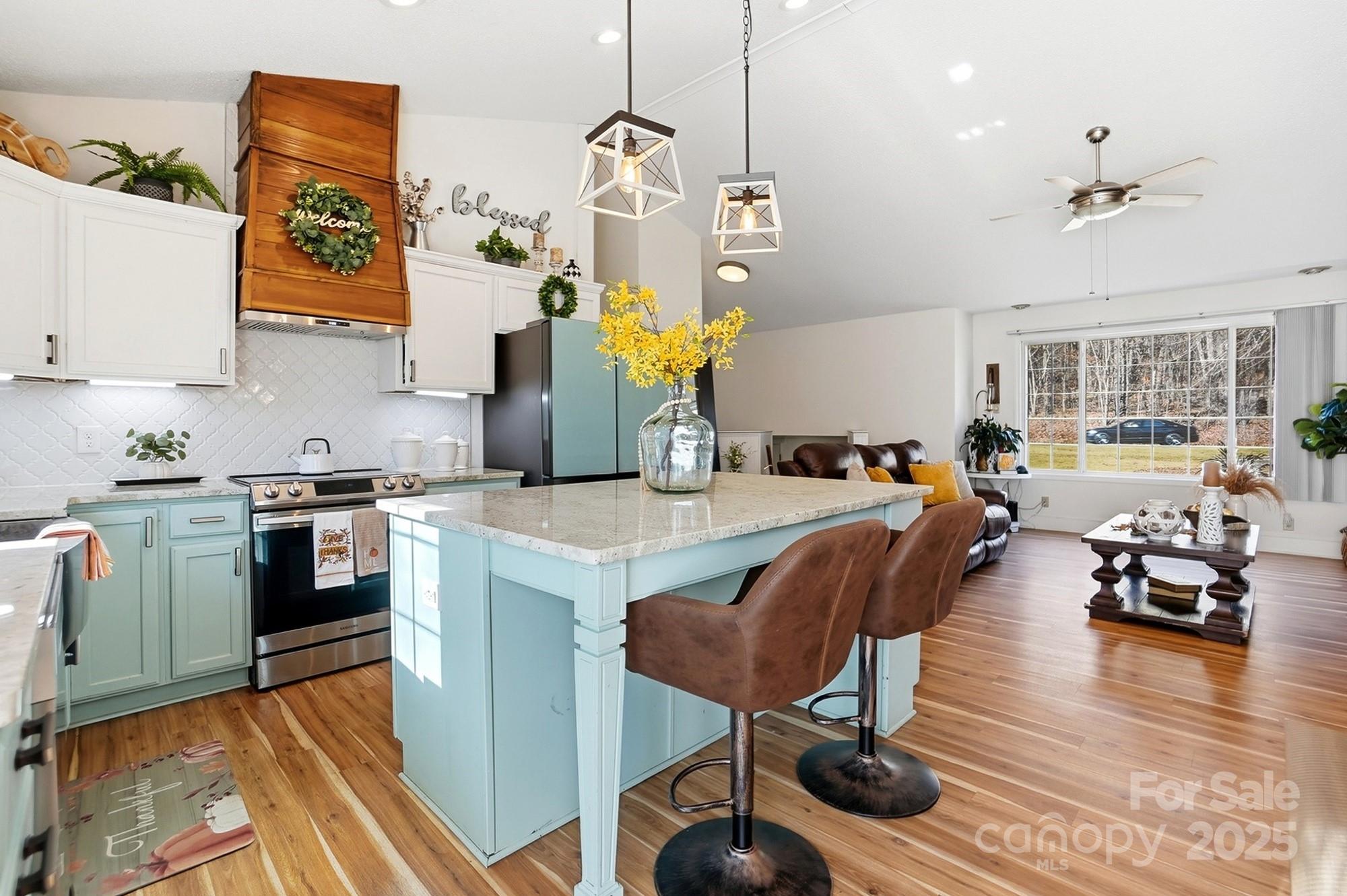 2012 Bethlehem Road Kings Mountain, NC 28086 - Photo 6 of 45 a kitchen with stainless steel appliances granite countertop a stove a sink dishwasher a dining table and chairs with wooden floor