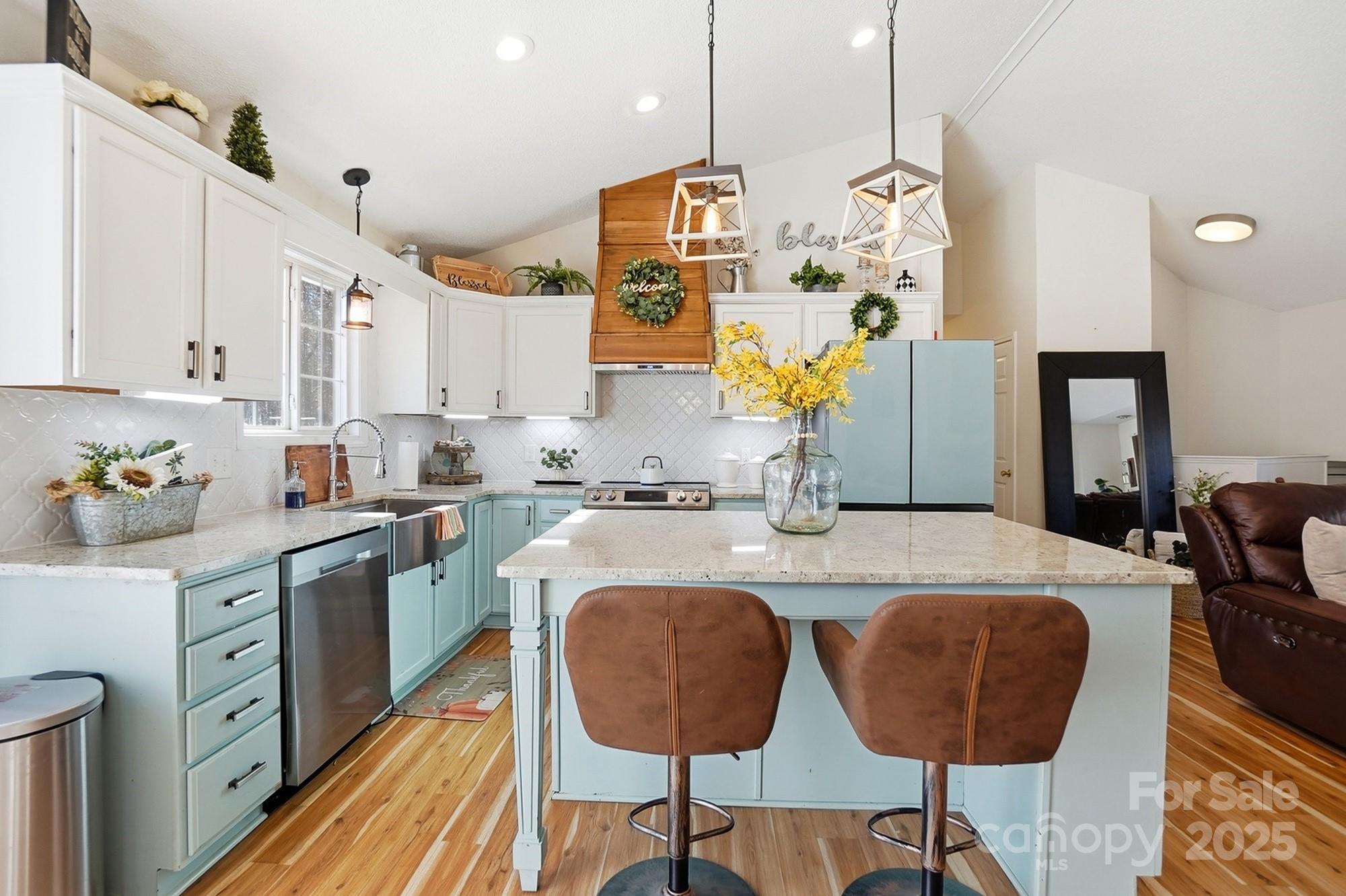 2012 Bethlehem Road Kings Mountain, NC 28086 - Photo 8 of 45 a kitchen with stainless steel appliances granite countertop a sink dishwasher and white cabinets with wooden floor
