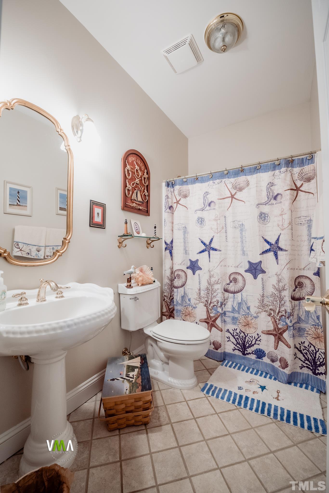 5417 Levering Mill Road Apex, NC 27539 - Photo 22 of 39 a bathroom with a sink mirror vanity and toilet