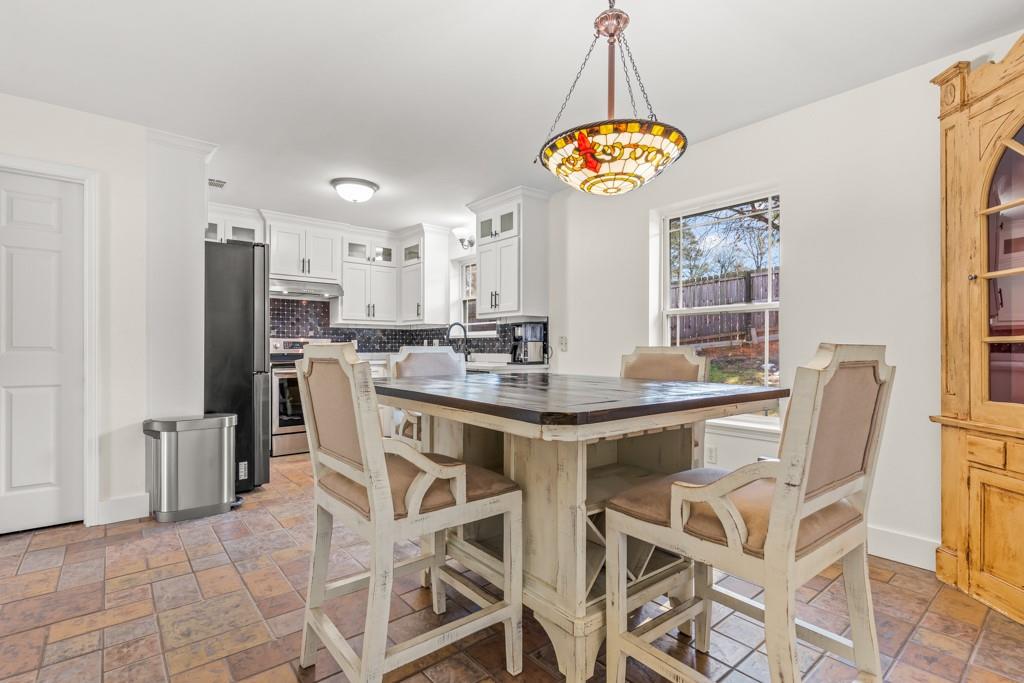 804 Alta Street Longview, TX 75604 - Photo 7 of 20 a dining room filled chandelier and kitchen view