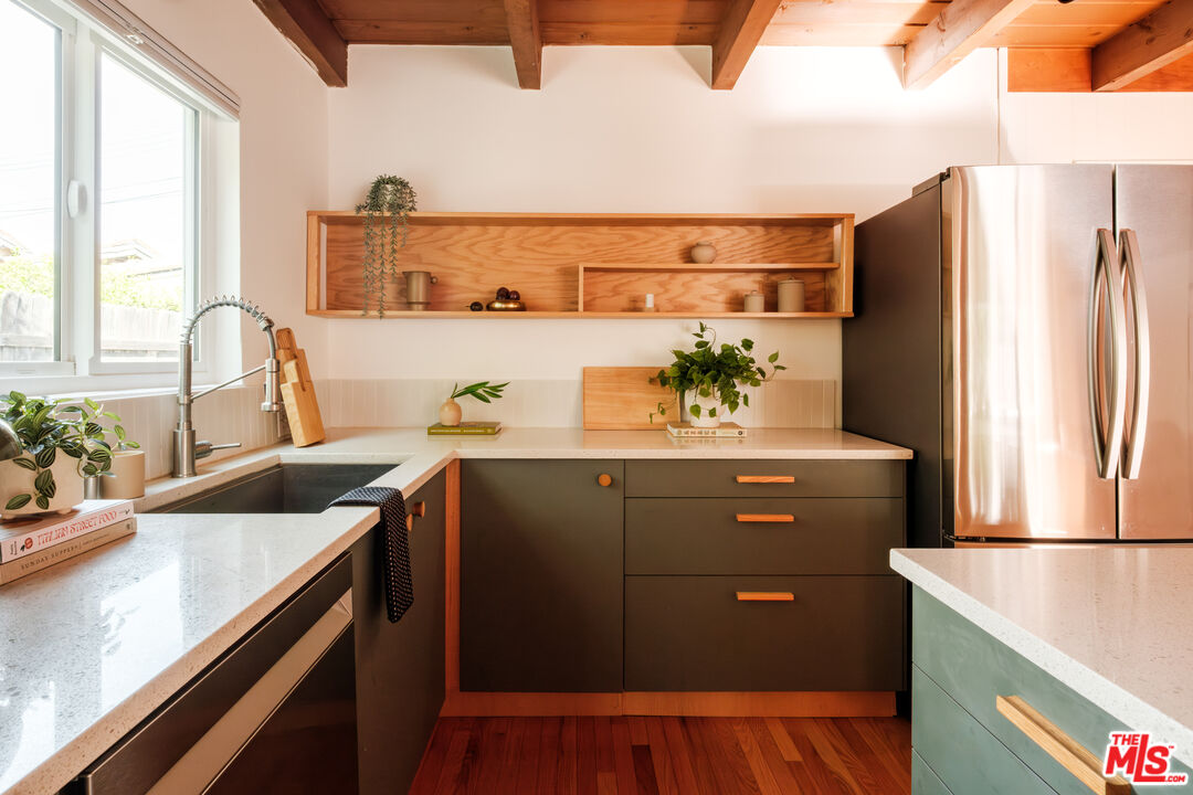 940 East Arroyo Terrace Alhambra, CA 91801 - Photo 16 of 54 a kitchen with stainless steel appliances granite countertop a sink and a refrigerator