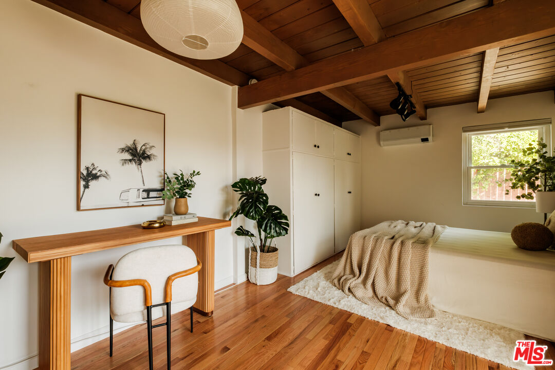 940 East Arroyo Terrace Alhambra, CA 91801 - Photo 37 of 54 a bedroom with a bed and dresser with wooden floor