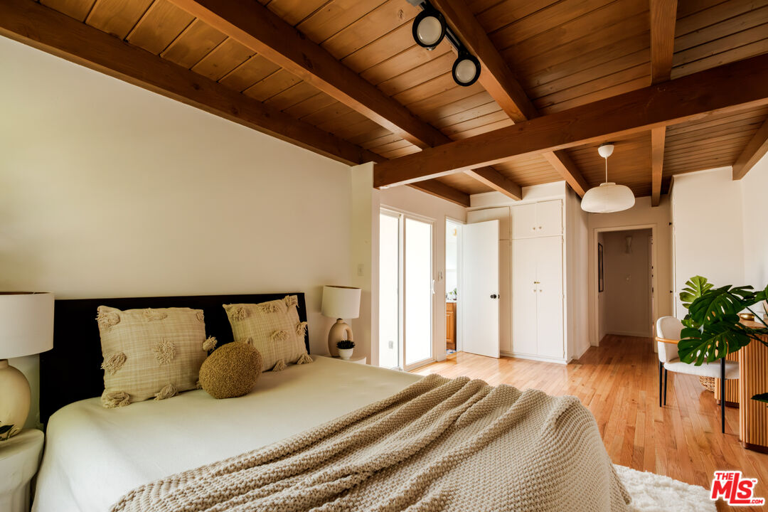 940 East Arroyo Terrace Alhambra, CA 91801 - Photo 39 of 54 a bedroom with a large bed and wooden floor