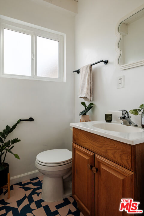 940 East Arroyo Terrace Alhambra, CA 91801 - Photo 40 of 54 a bathroom with a sink mirror vanity and toilet