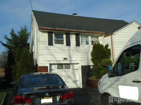 a front view of a house with parking space