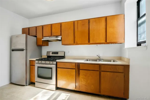 a kitchen with a sink stove and refrigerator