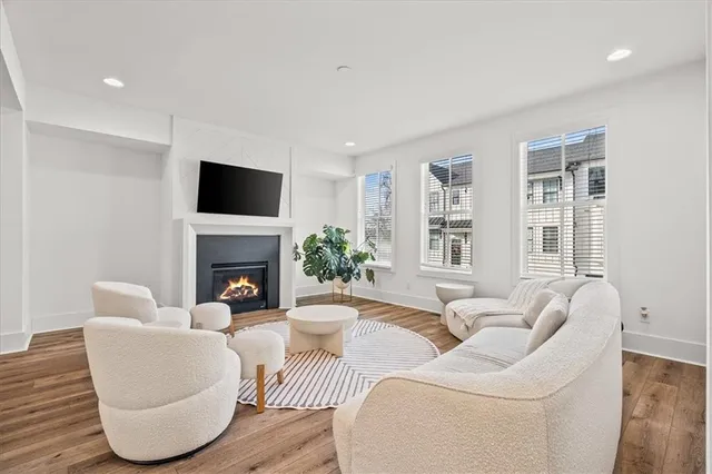 a living room with furniture a fireplace and a flat screen tv