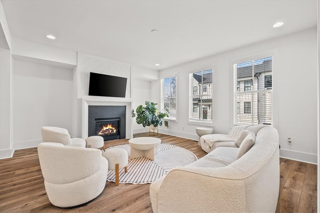 5862 Westin Road Atlanta, GA 30328 - Photo 11 of 43 a living room with furniture a fireplace and a flat screen tv