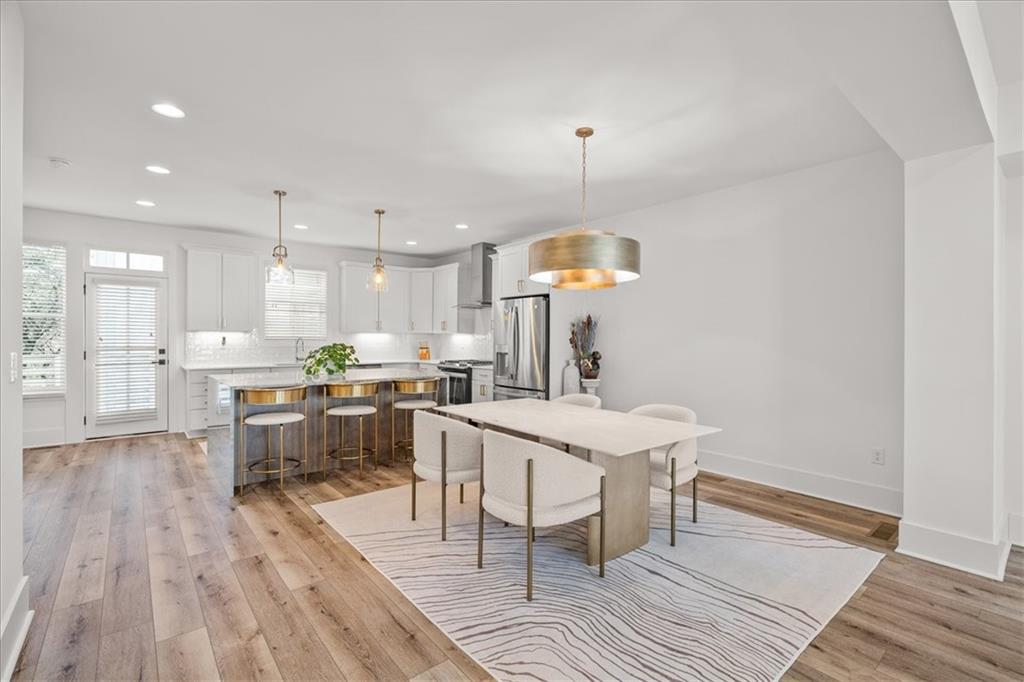 5862 Westin Road Atlanta, GA 30328 - Photo 13 of 43 a kitchen with a table chairs refrigerator and wooden floor