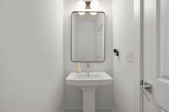a bathroom with a sink and mirror