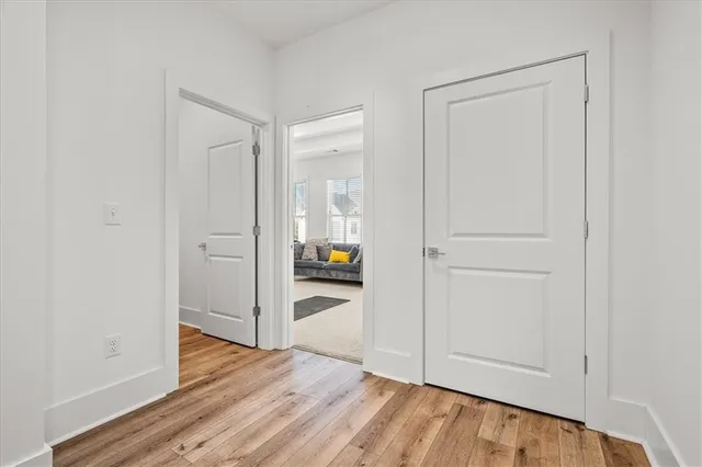 a view of a hallway with wooden floor