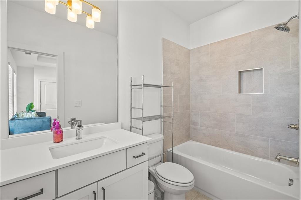 5862 Westin Road Atlanta, GA 30328 - Photo 29 of 43 a bathroom with a bathtub shower sink vanity and toilet