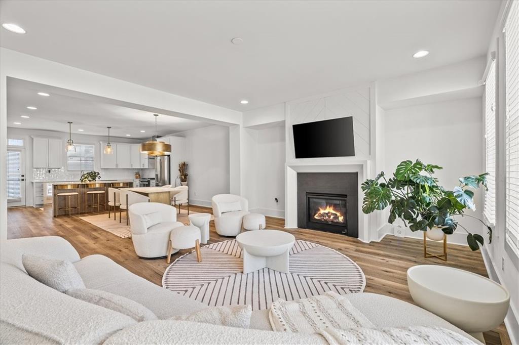 5862 Westin Road Atlanta, GA 30328 - Photo 3 of 43 a living room with furniture a fireplace and a potted plant