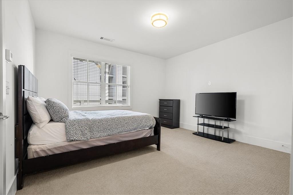 5862 Westin Road Atlanta, GA 30328 - Photo 34 of 43 a bedroom with bed tv and window