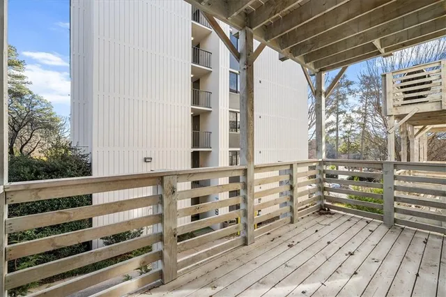 a view of a balcony with wooden floor and windows