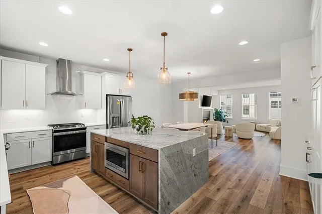 a kitchen with stove and wooden floor