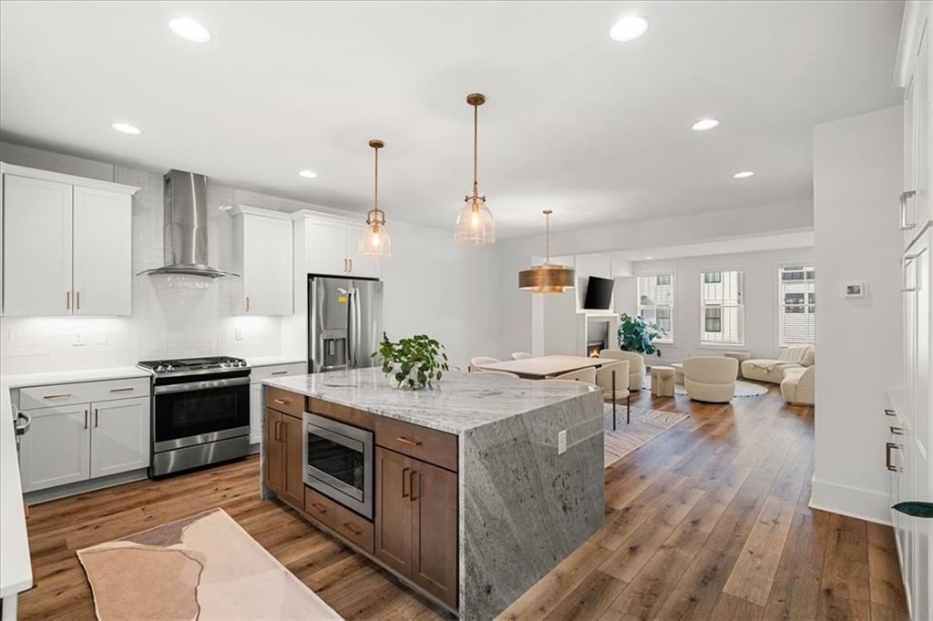 5862 Westin Road Atlanta, GA 30328 - Photo 4 of 43 a kitchen with stove and wooden floor