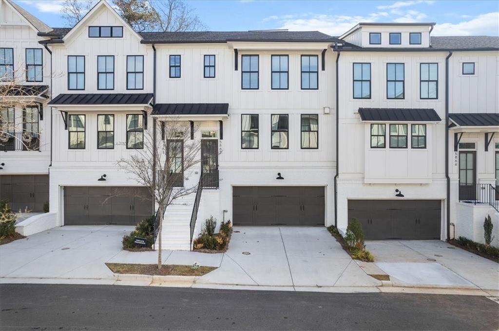 5862 Westin Road Atlanta, GA 30328 - Photo 43 of 43 a front view of a building with a yard and parking space
