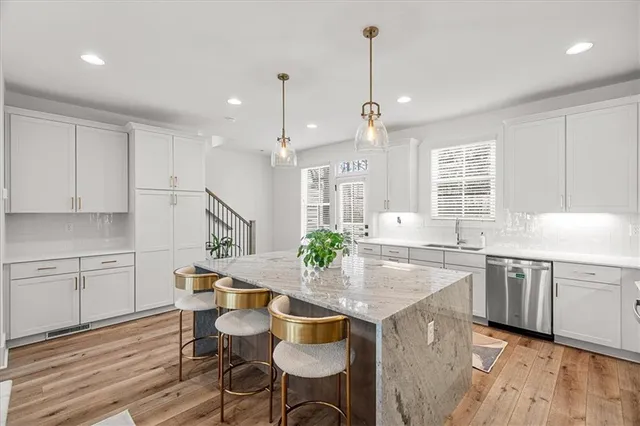 a kitchen with center island table and chairs in it