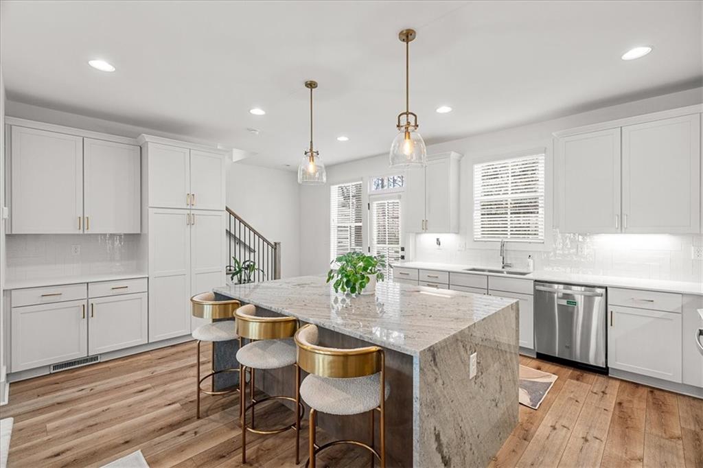 5862 Westin Road Atlanta, GA 30328 - Photo 7 of 43 a kitchen with center island table and chairs in it
