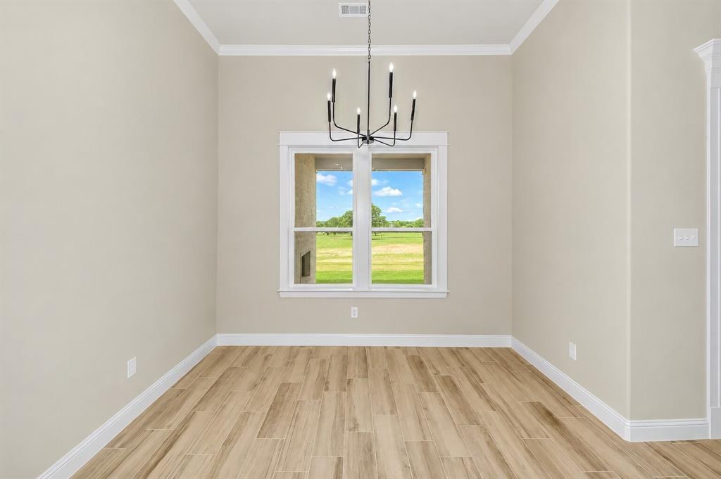 1057 Vh Ranch Poolville, TX 76487 - Photo 15 of 38 an empty room with wooden floor a ceiling fan and window