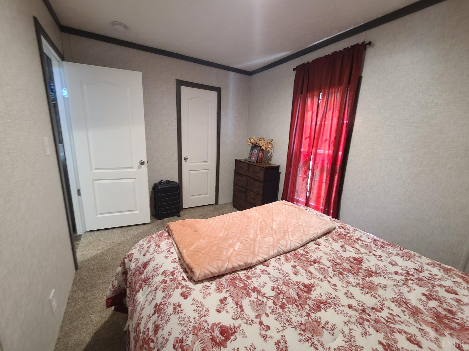 344 Midway Road Phenix, VA 23959 - Photo 27 of 37 a bedroom with a bed and a mirror