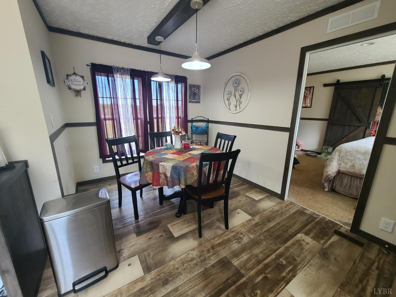 344 Midway Road Phenix, VA 23959 - Photo 9 of 37 a view of a dining room with furniture window and wooden floor