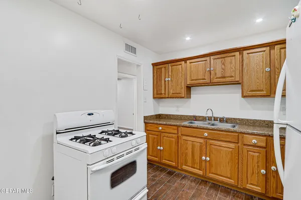 a kitchen with stainless steel appliances granite countertop a stove and a sink