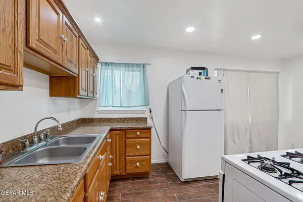 a kitchen that has a sink and a refrigerator