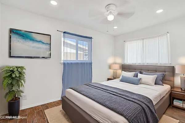 a bedroom with a bed and a potted plant