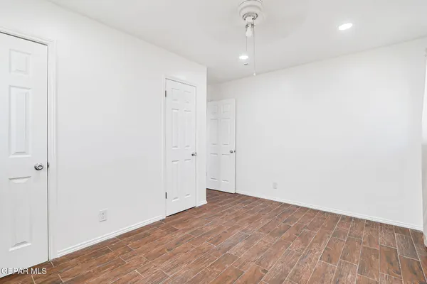 an empty room with wooden floor